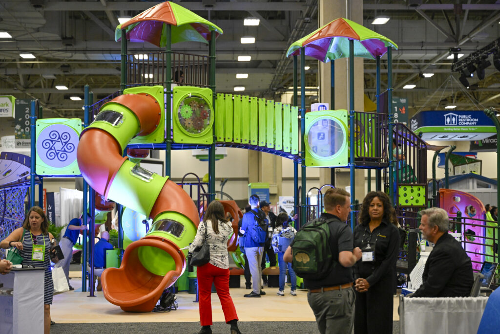 A group gathers around a playground set up in the exhibit hall