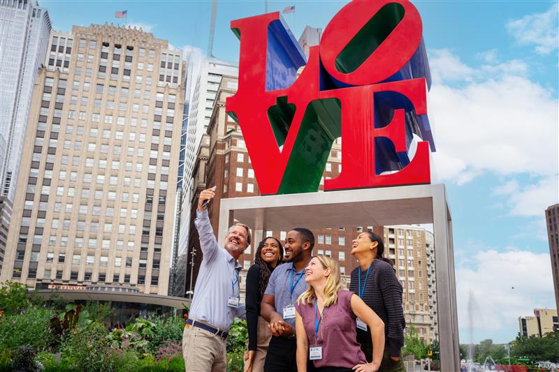 A group of tourist pose in front of the LOVE statue in Philadelphia