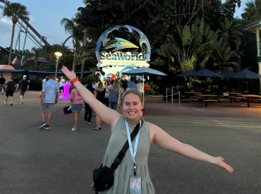 Lacey Polster (NRPA Annual Conference attendee) poses in front of Orlando theme park sign